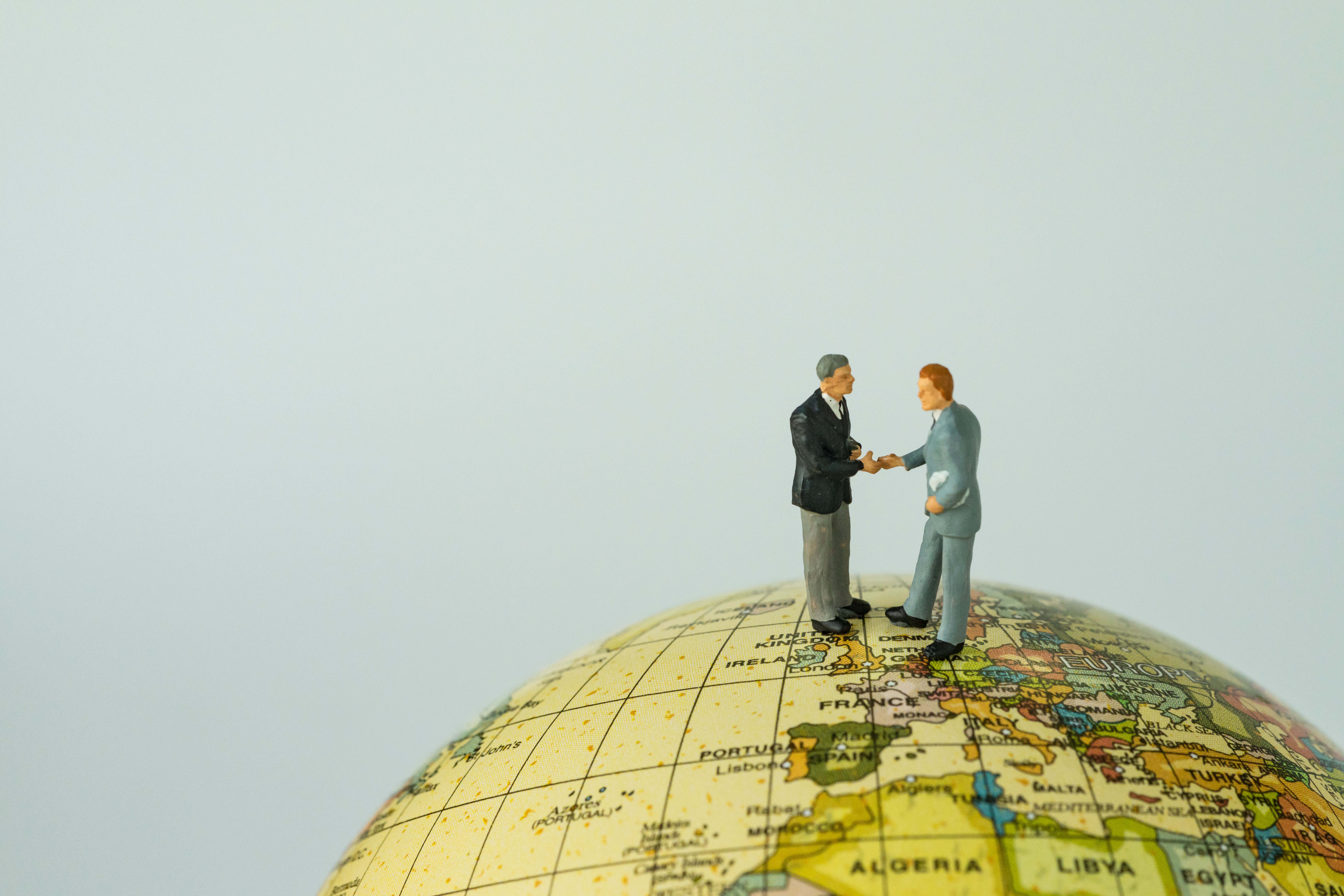 Miniature people small figure businessmen handshaking on Europe