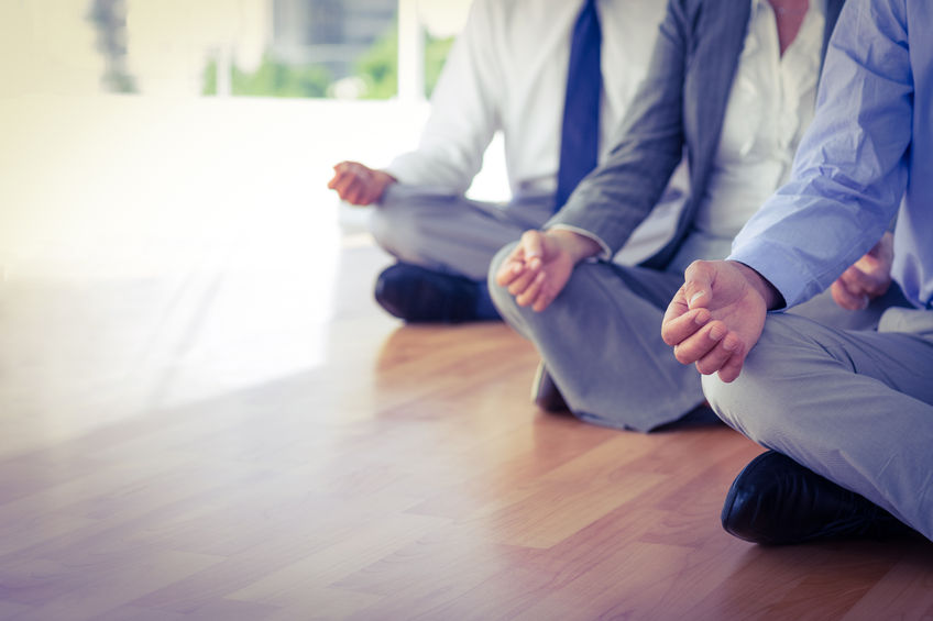 44785138 – close up view of business people doing yoga in office
